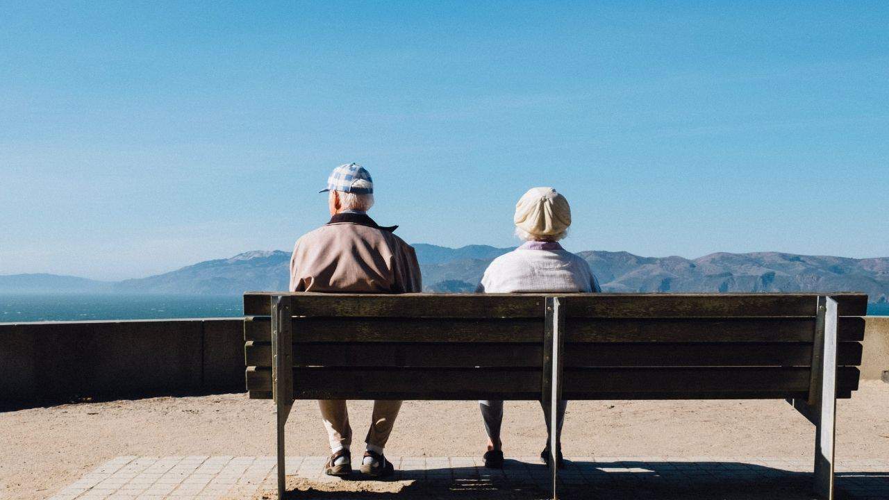 An-older-couple-sitting-on-a-bench-1.jpeg