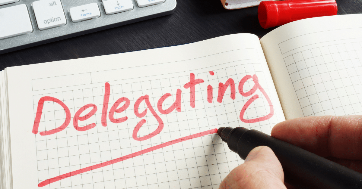 Man-writing-delegating-on-notebook.png