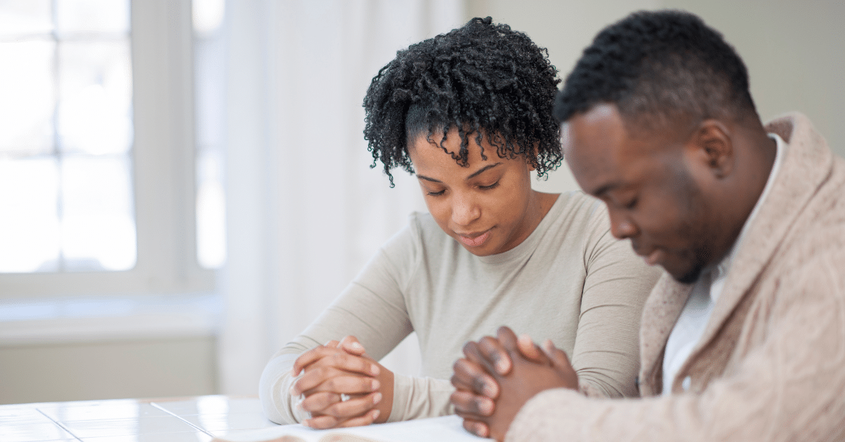 Couple-Praying-Together-With-Bible.png