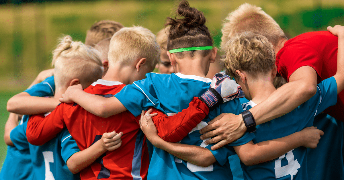 Youth-Sports-Coach-with-Kids-on-Soccer-Field.png