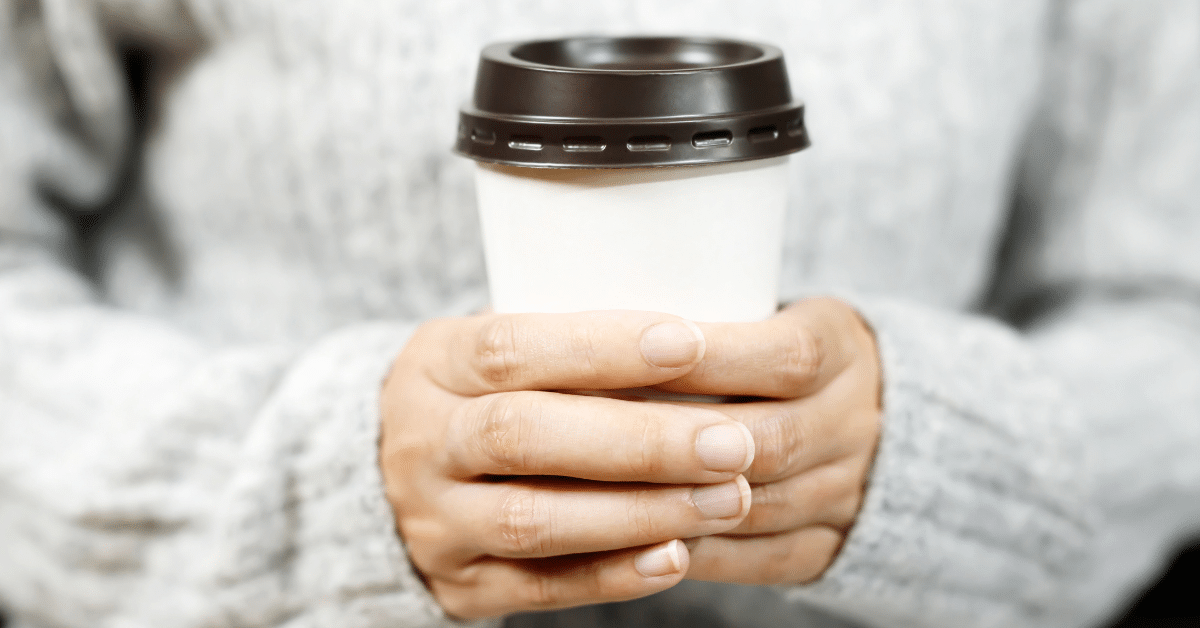 Woman-Holding-Coffee-Cup.png